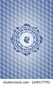 head with gears inside icon inside blue emblem or badge with geometric pattern background.