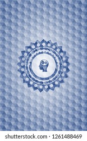 head with gears inside icon inside blue emblem with geometric background.