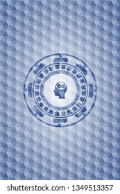 head with gears inside icon inside blue emblem or badge with geometric pattern background.