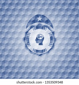 head with gears inside icon inside blue emblem or badge with geometric pattern background.