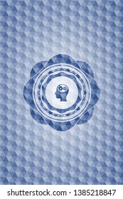 head with gears inside icon inside blue emblem or badge with abstract geometric pattern background.