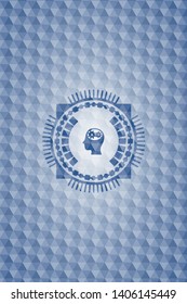 head with gears inside icon inside blue polygonal badge.