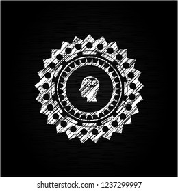head with gears inside icon inside chalkboard emblem written on a blackboard