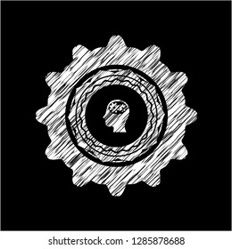 head with gears inside icon drawn on a blackboard