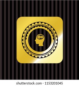 head with gears inside icon inside gold badge or emblem
