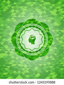 head with gears inside icon inside green emblem with triangle mosaic background