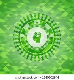 head with gears inside icon inside green emblem. Mosaic background