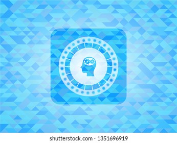 head with gears inside icon inside light blue emblem. Mosaic background