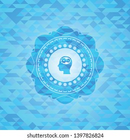head with gears inside icon inside light blue emblem with triangle mosaic background