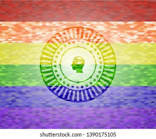 head with gears inside icon on mosaic background with the colors of the LGBT flag
