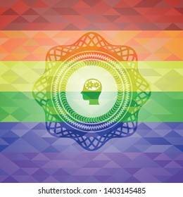 head with gears inside icon on mosaic background with the colors of the LGBT flag