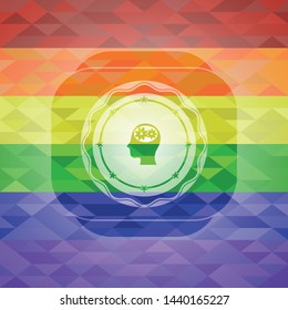 head with gears inside icon on mosaic background with the colors of the LGBT flag