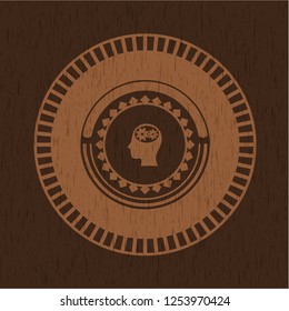 head with gears inside icon inside realistic wooden emblem