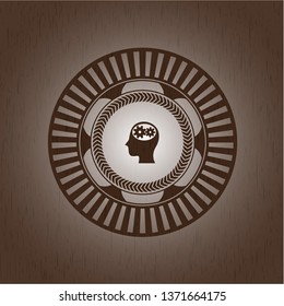 head with gears inside icon inside realistic wooden emblem