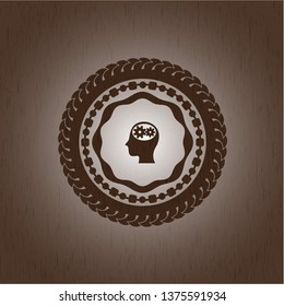 head with gears inside icon inside realistic wooden emblem