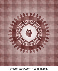 head with gears inside icon inside red seamless emblem or badge with geometric pattern background.
