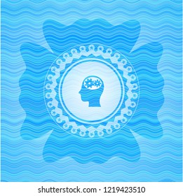 head with gears inside icon inside water representation emblem.