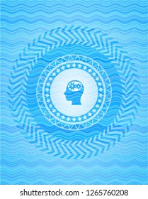 head with gears inside icon inside water style emblem.