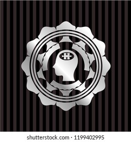 head with jigsaw puzzle piece icon inside silver emblem