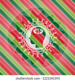 head with jigsaw puzzle piece icon inside christmas badge.