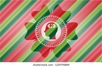 head with jigsaw puzzle piece icon inside christmas colors style badge.