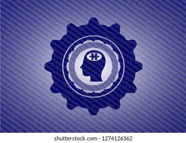 head with jigsaw puzzle piece icon inside badge with denim background