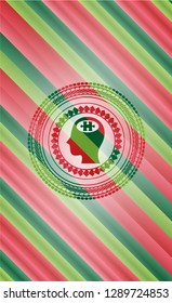 head with jigsaw puzzle piece icon inside christmas colors badge.