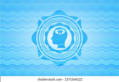 head with jigsaw puzzle piece icon inside sky blue water wave emblem.