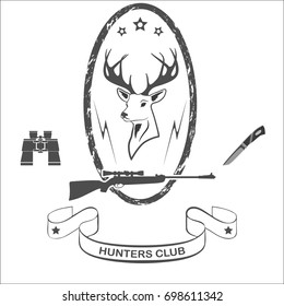 Head of a red deer, rifle with a sight, binoculars and a hunter's knife