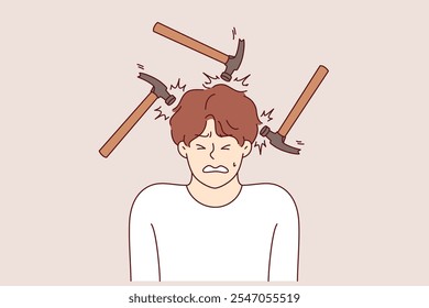 Headache and migraine torment man making painful grimace, standing among hammers. Problem of headaches caused by stress and noisy neighbors necessitates taking antibiotics and painkillers