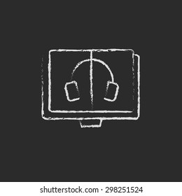 Headphone in screen monitor hand drawn in chalk on a blackboard vector white icon on a black background