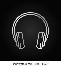 Headphone silver outline icon. Vector headphones concept symbol or design element in linear style on dark background