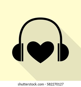 Headphones with heart. Black icon with flat style shadow path on cream background.