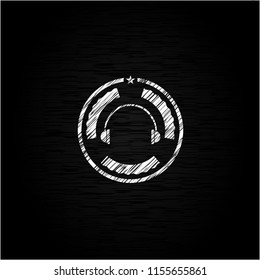 headphones icon inside chalk emblem written on a blackboard