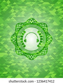 headphones icon inside green emblem with mosaic ecological style background