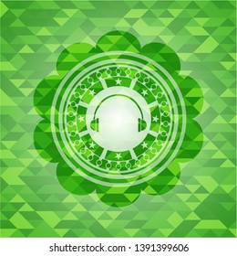 headphones icon inside green emblem with mosaic ecological style background