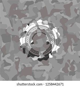 headphones icon inside grey camouflaged emblem