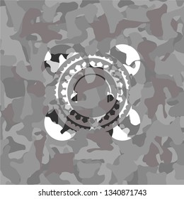 headphones icon inside grey camouflaged emblem