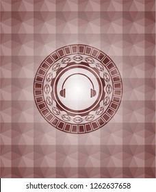 headphones icon inside red seamless emblem or badge with abstract geometric pattern background.