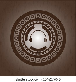 headphones icon inside retro style wooden emblem
