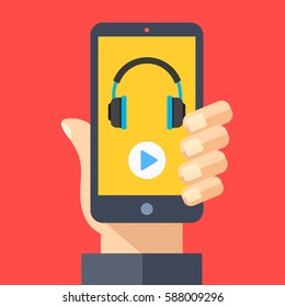 Headphones and play button on smartphone screen. Hand holding smartphone. Streaming service, music app, listening to music on mobile device. Modern flat design graphic elements. Vector illustration