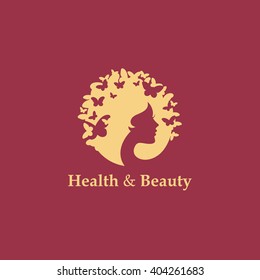 Health and beauty logo concept: woman's face and butterflies. Logo for beauty salon, massage, cosmetics, spa or medical clinic. Flat design.
