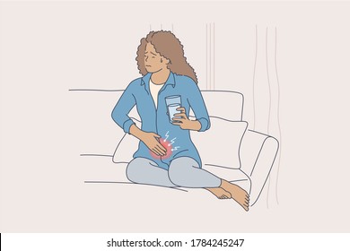 Health, care, medicine, hurt concept. Young sad african american woman girl frowning in ibd pain sitting on couch covering stomach holding glass of water. Abdominal desease or digestive system problem