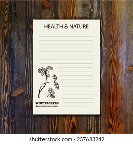 Health and Nature Collection. Banner template with a herb on wooden background. Wintergreen - Gaultheria procumbens