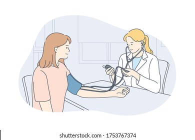 Healthcare, examination, medicine concept. Young happy woman doctor physician medical worker cartoon character talks with girl patient measuring heart rate at hospital. Health checkup and medical care