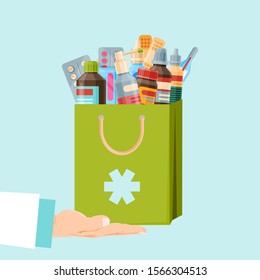 Healthcare and shopping, drug store, pharmacy shopping bag. First aid package, health care vector illustration. Pharmacist or doctor hand holds a paperbag with medicine