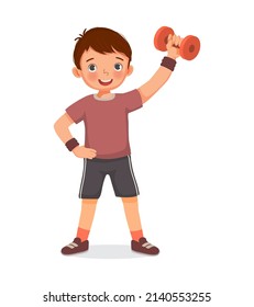 Healthy cute little boy doing sport exercises fitness workout with dumbbells