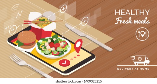 Healthy food delivery at home and smartphone app: healthy take away food on a smartphone and table set, technology and catering concept