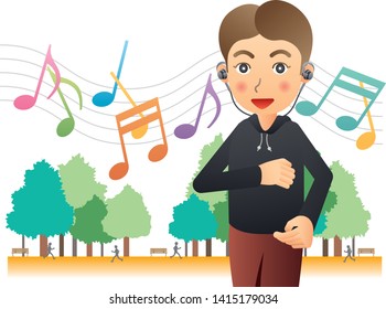 Healthy man jogging while listening to music with earphones in the park