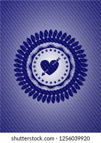 heart with arrow icon inside badge with denim texture
